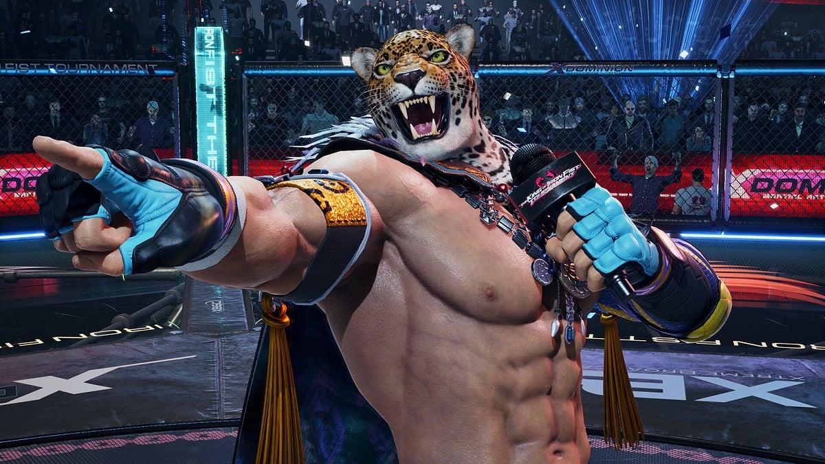 Tekken 8 - King, a man in a tiger mask, holds a microphone and points.